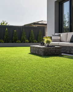 Artificial grass carpet in a modern outdoor patio by Rug Dubai.