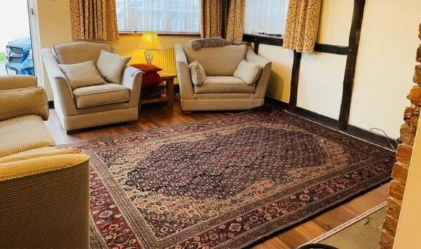 Durable Persian Rug and Sofa Set in a Room
