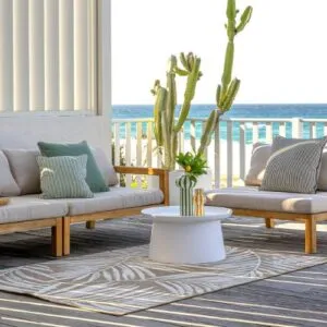 Indoor outdoor rug beneath lounge seating on a sea-view balcony