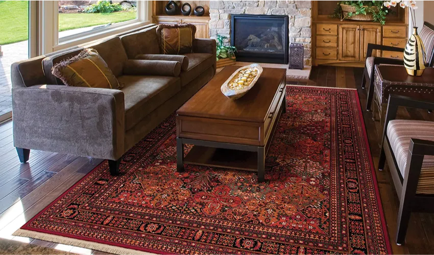 Red Persian rug with a floral field and a wide patterned border